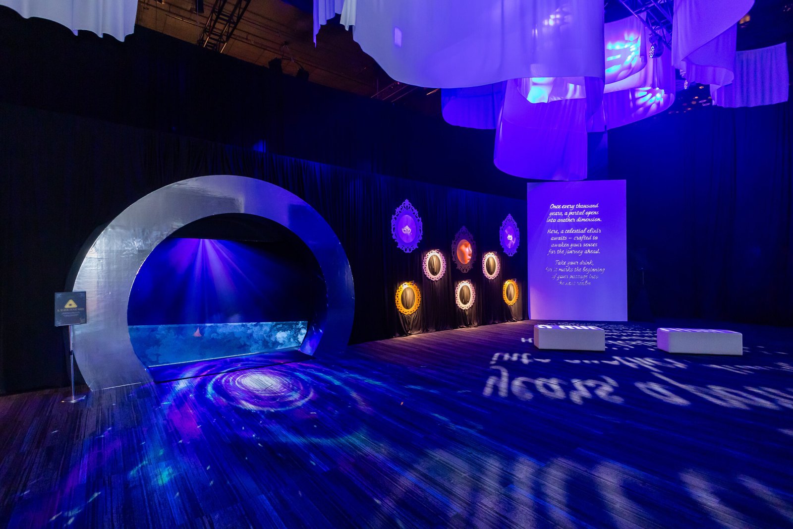 Stellar Masquerade gala stage with elaborate purple-neon lighting, sculptural arch installation, and celestial medallion
